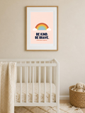Be Kind. Be Brave. nursery poster in a frame on the wall of a soft children's room