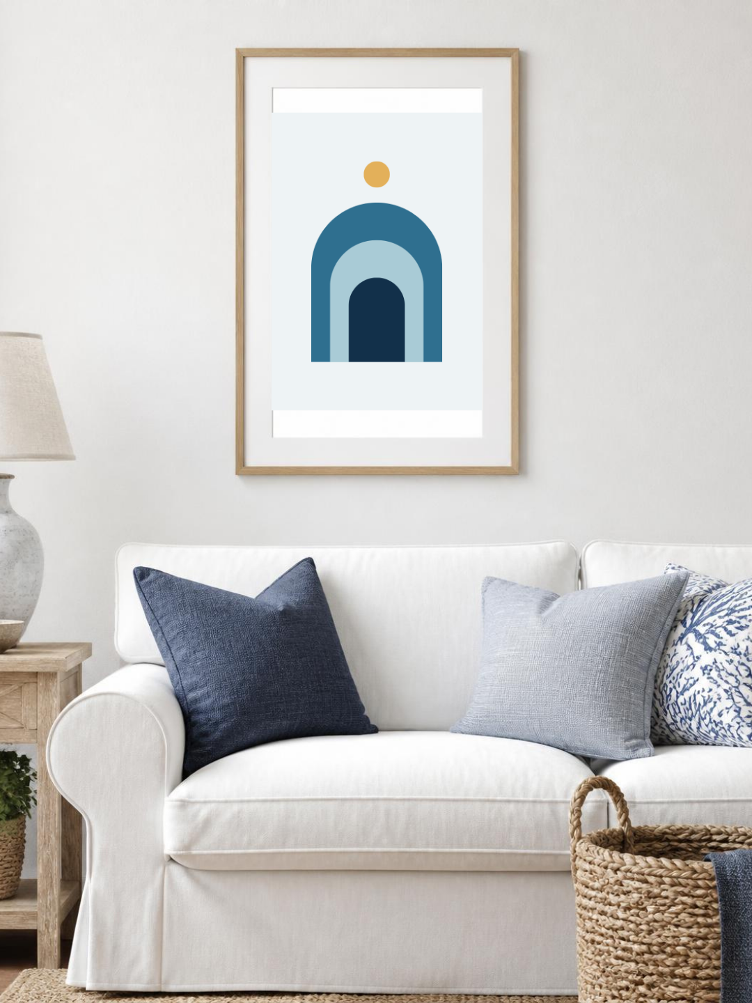 Ocean Arches poster in a frame above a white sofa – room mockup