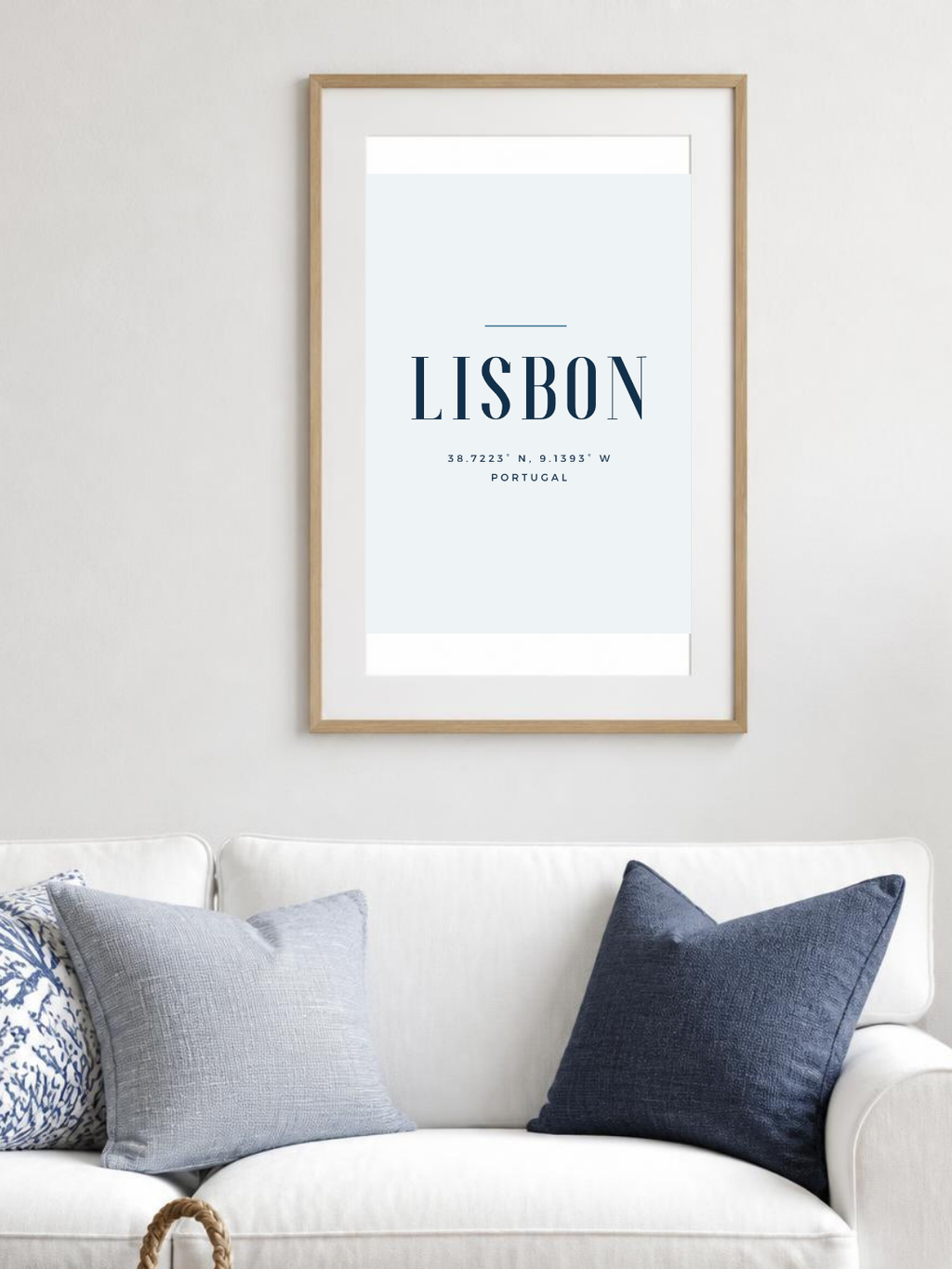 Lisbon poster in a frame above a white sofa – room mockup